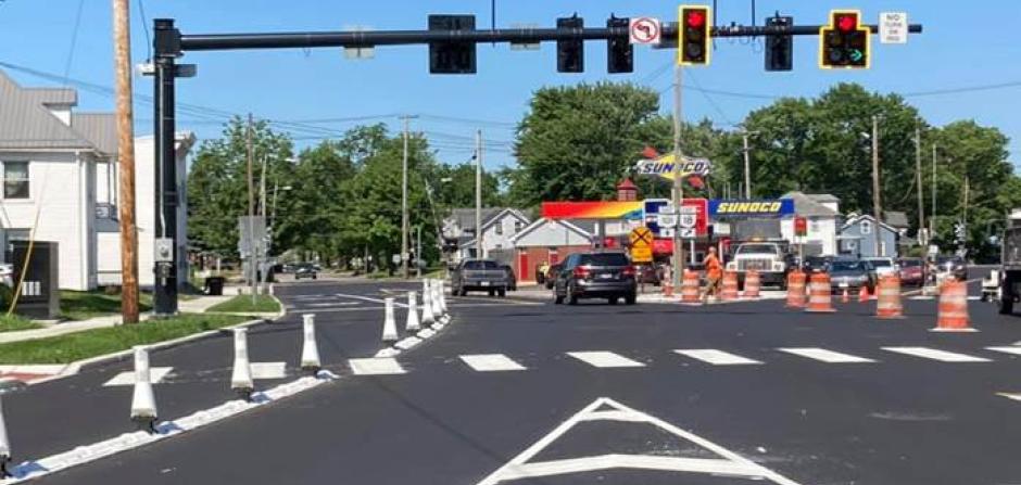 Picture of painted lines on a street and traffic signals