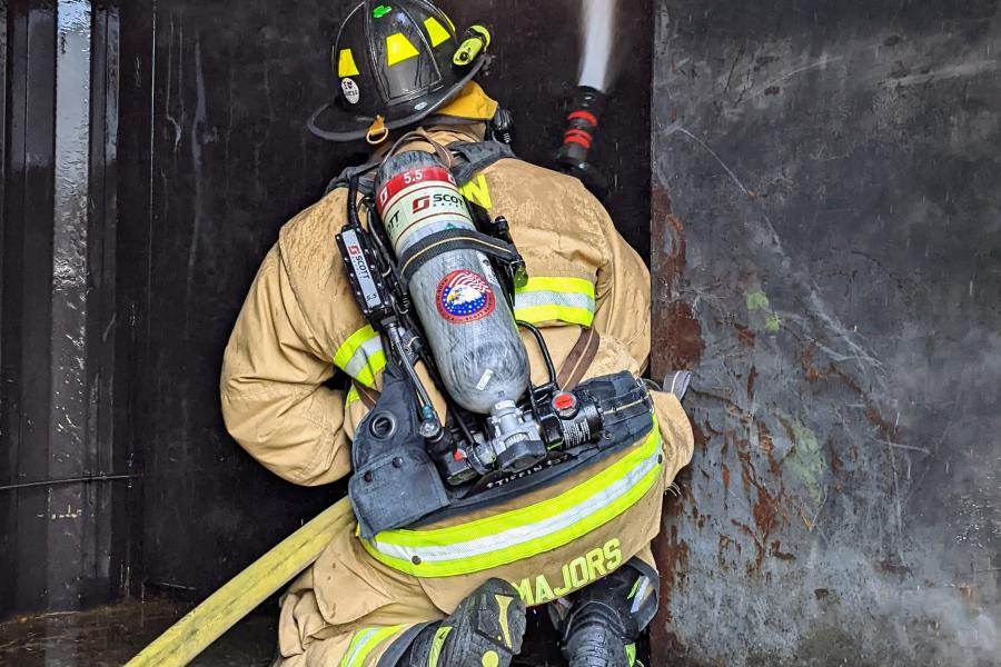 A Tiffin firefighter uses a hose during a training exercise in 2022. Tiffin Fire/Rescue Division recently received a federal grant to provide for new Self Contained Breathing Apparatus equipment, such as the air pack which is worn on the back of the firefighter pictured.