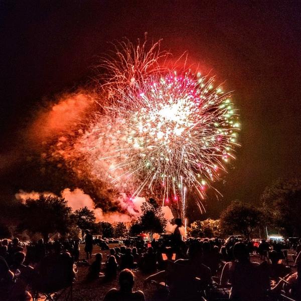 A crowd of people watch fireworks explode at the Independence Day Celebration on July 4, 2022, at Hedges-Boyer Park, Tiffin.